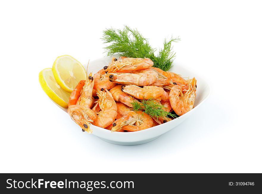 Delicious Big Boiled Shrimps Served with Dill and Lemon Slices in White Bowl isolated on white background
