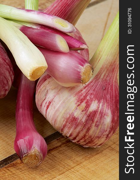 New Harvest Garlic and Pink Onion closeup on Wooden background. New Harvest Garlic and Pink Onion closeup on Wooden background