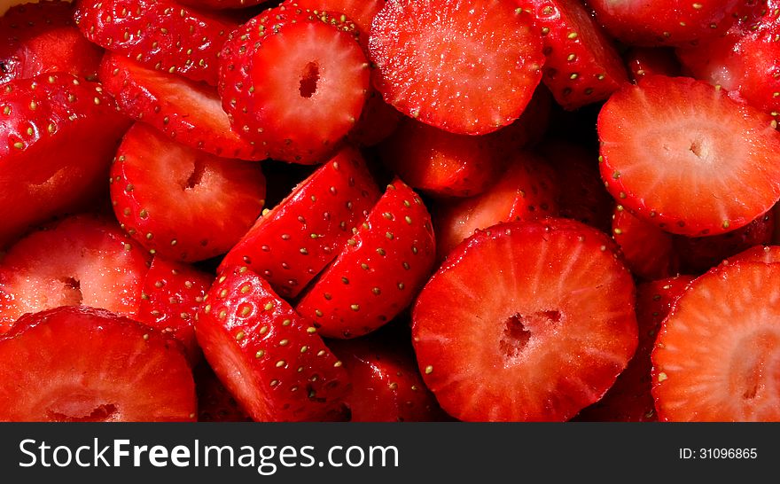 Background, macro shot of chopped strawberries, horizontal orientation