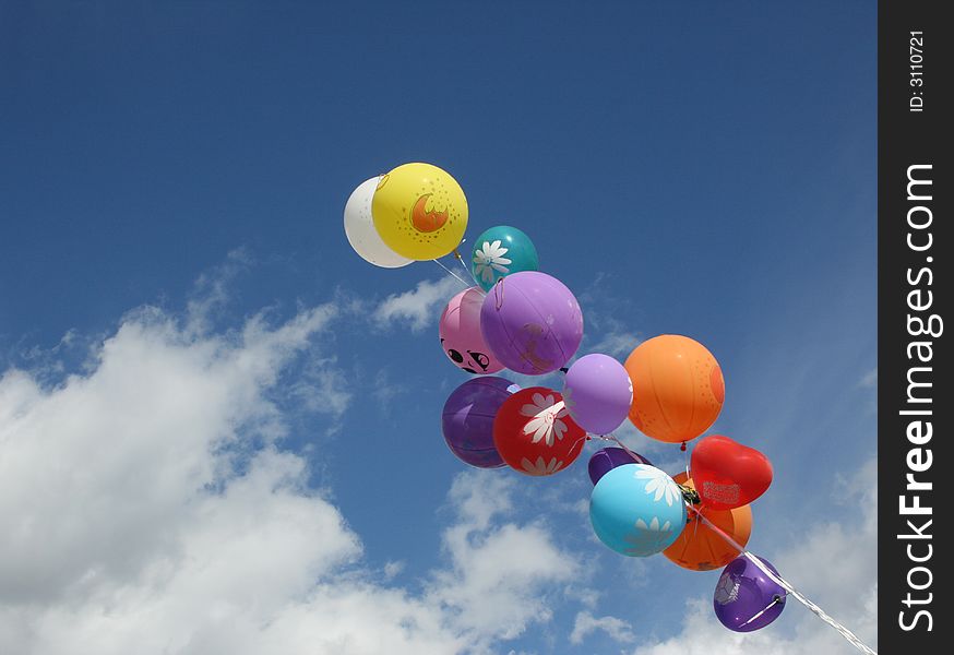 Multi-coloured balloons on a background of the dark blue sky