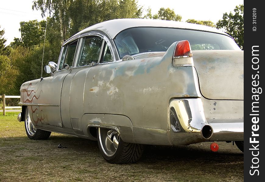 A Cool and beat up 1950s classic american car painted with red flames. A Cool and beat up 1950s classic american car painted with red flames