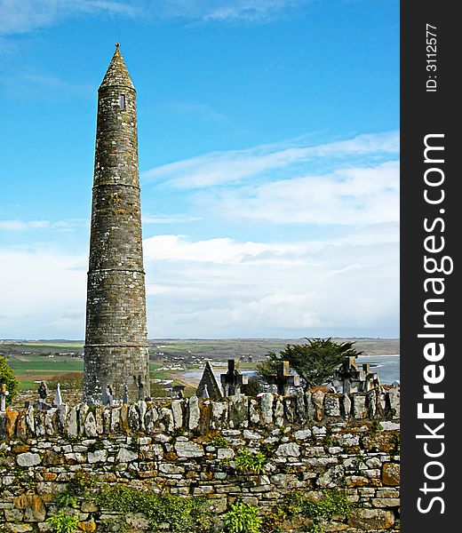 A view of a tipical irish landscape with the grain tower and a small cemetery of a medieval abbey. A view of a tipical irish landscape with the grain tower and a small cemetery of a medieval abbey