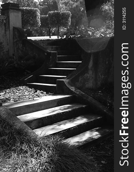 Shadowy garden staircase in an outdoor garden. Shadowy garden staircase in an outdoor garden