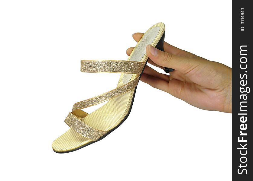 Golden woman's shoe in hand isolated on white background