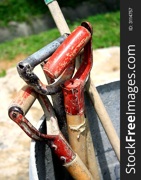 Handles of construction tools put aside during break time. Handles of construction tools put aside during break time.