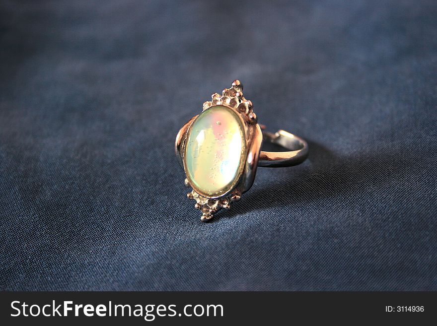 Nice ring with colorful stone on the gray. Nice ring with colorful stone on the gray.