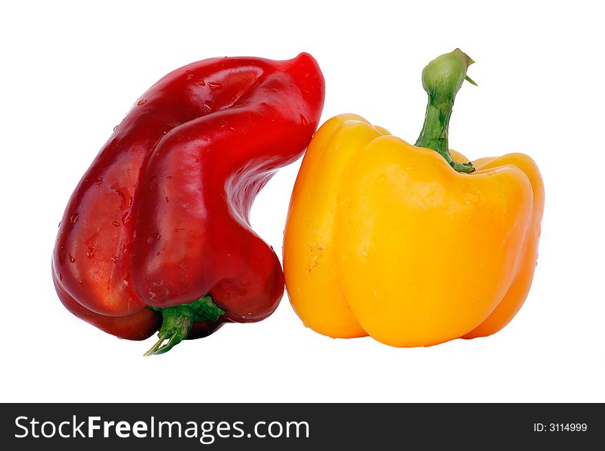 Red and yellow bell-peppers with water drops isolated on white