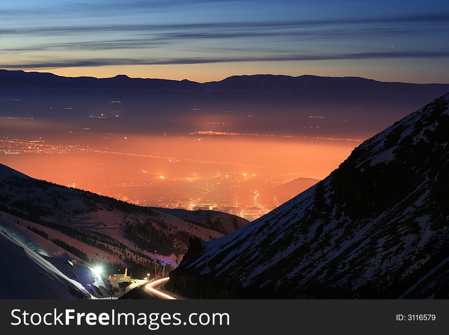 A photo of a night city lanscape from mountain. A photo of a night city lanscape from mountain
