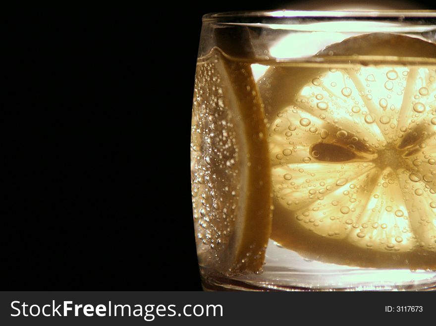An image of a lemon in a glass. An image of a lemon in a glass