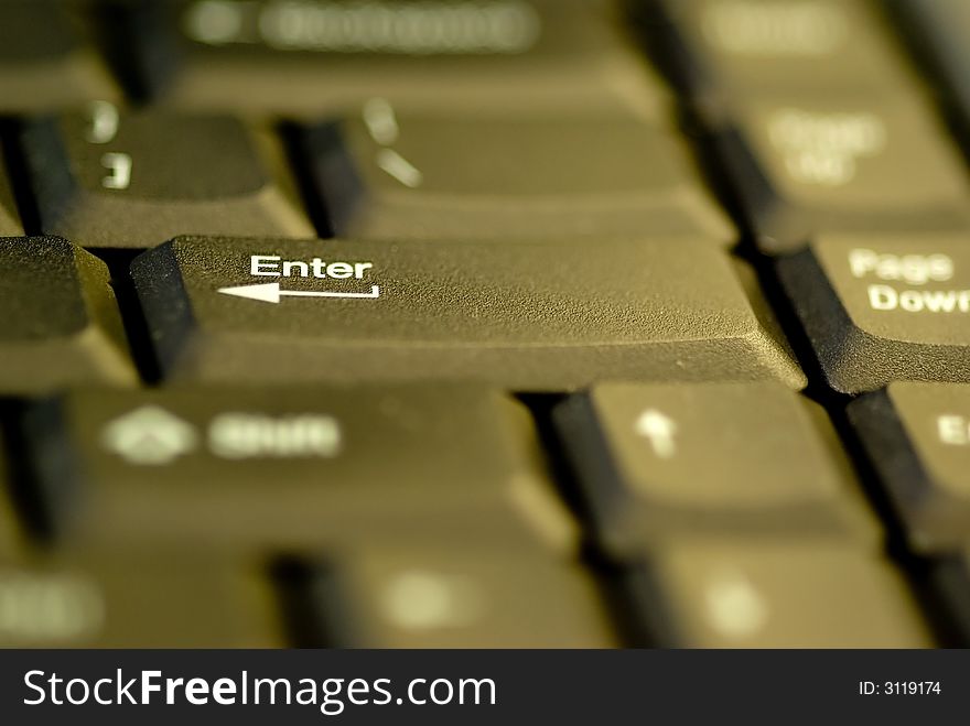 A closeup of a keyboard's enter key with shallow DOF