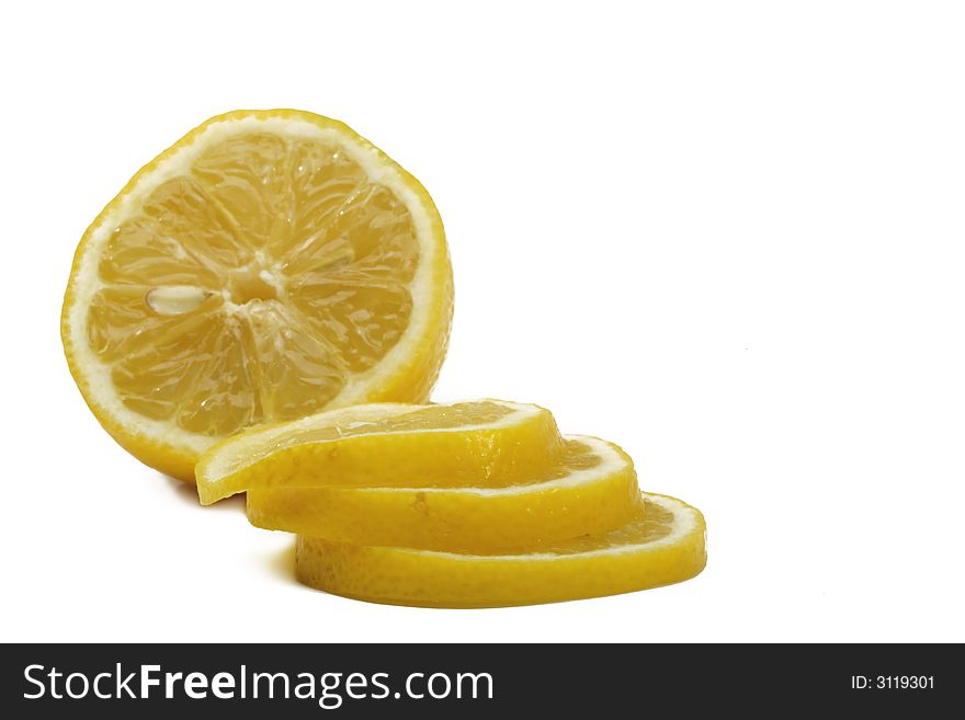 A yellow lemon with tree slice over white background. A yellow lemon with tree slice over white background