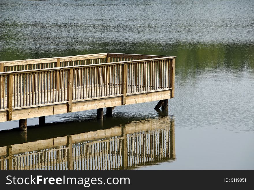 A walkway to a secluded platform on the lake. A walkway to a secluded platform on the lake