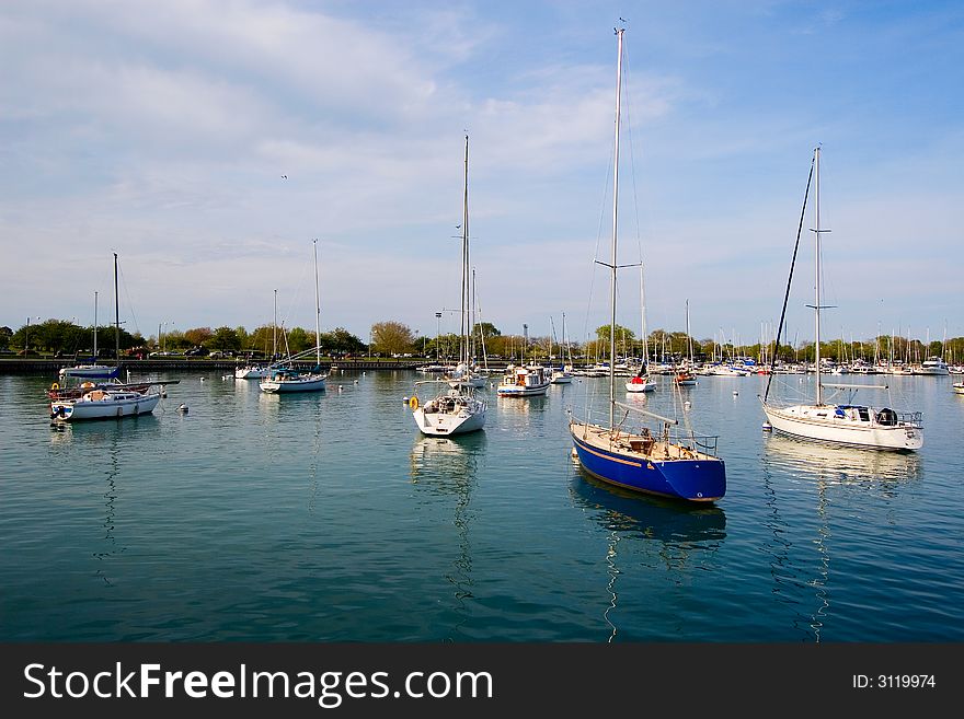 Sailboats moored in bay with blue water. Sailboats moored in bay with blue water