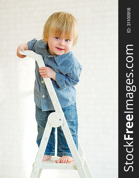 Cute little boy learning to climb the ladder. Cute little boy learning to climb the ladder