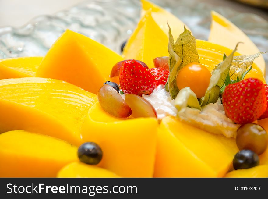 Fresh sliced mangoes with strawberries