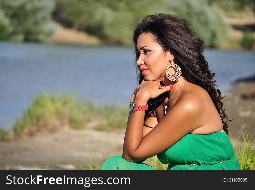 Outdoor portrait of an attractive young woman with long black hair . Outdoor portrait of an attractive young woman with long black hair .