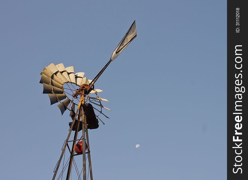 Windmill on farm with moon