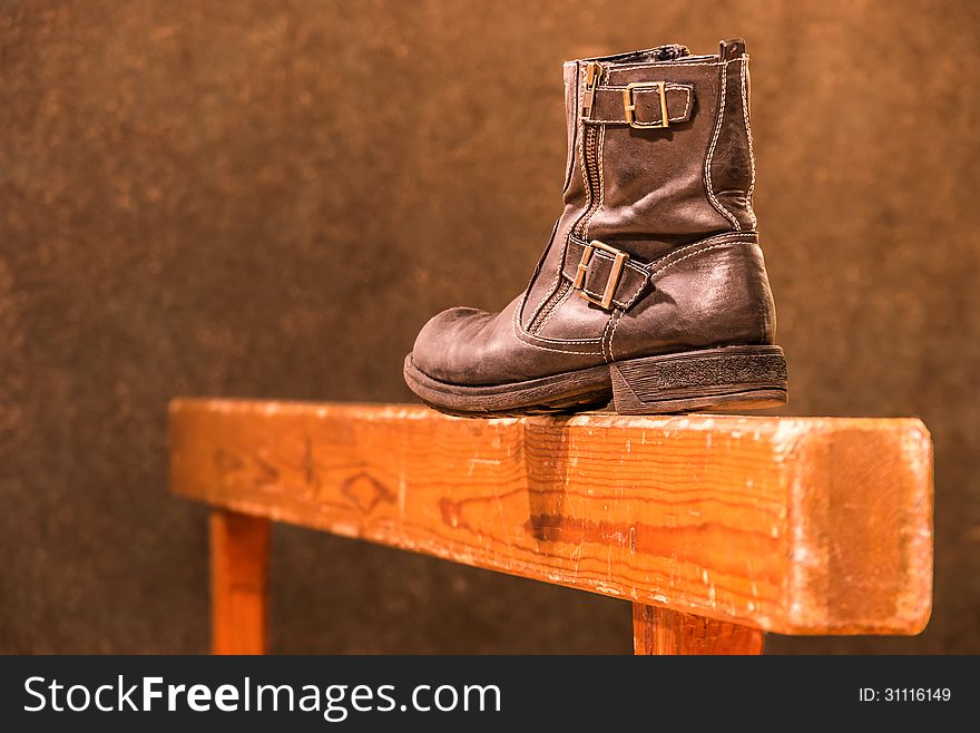 Perspective view of a vintage gymnastic beam with an old fashioned used boot. Perspective view of a vintage gymnastic beam with an old fashioned used boot.