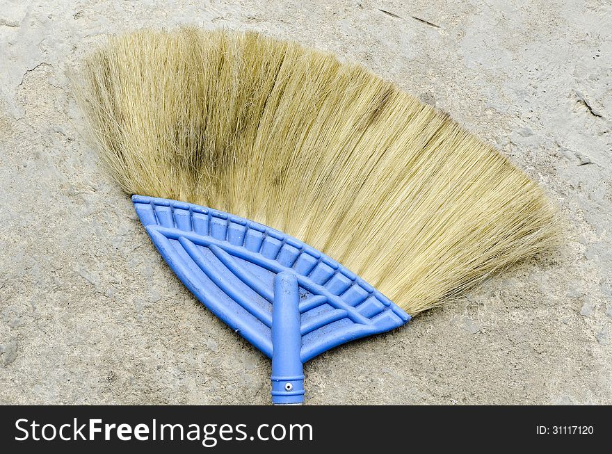 Used Broom with concrete floor