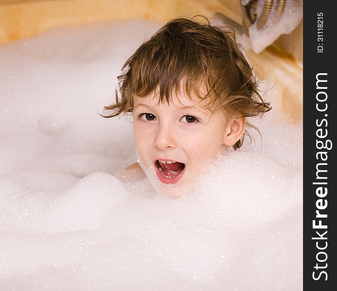 Cute little boy in bathroom with foam close up