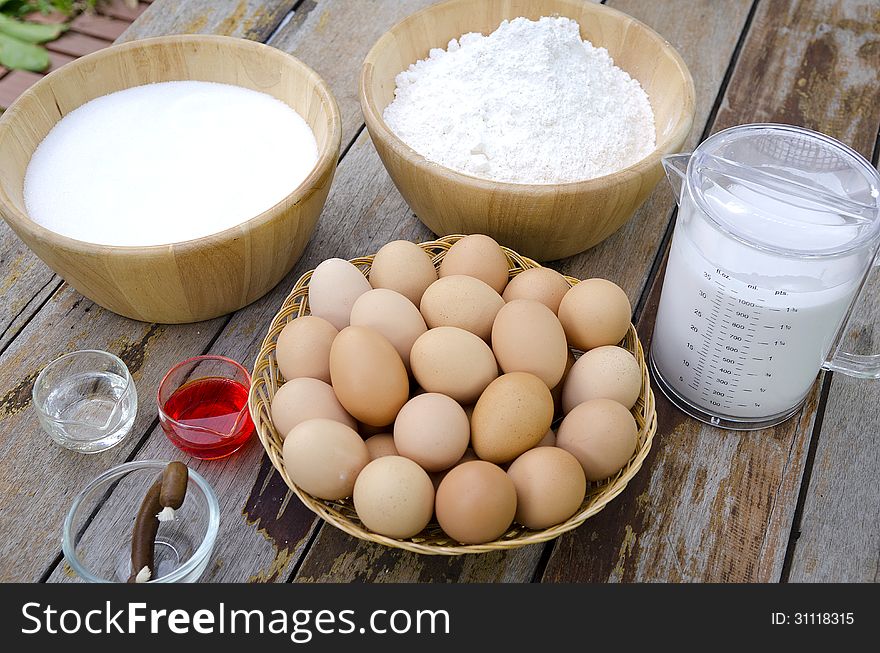 Eggs in basket and coconut milk sugar ฟืก wheat flour on wood table. Eggs in basket and coconut milk sugar ฟืก wheat flour on wood table