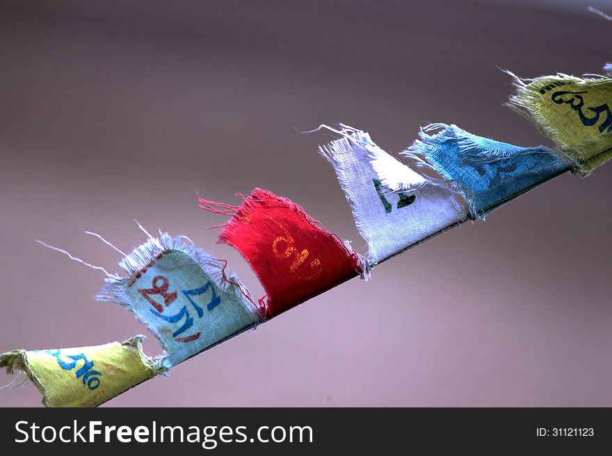 Buddhist prayer flags flying with wind