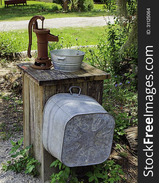 Old Water Pump and Buckets on a Florida farm. Old Water Pump and Buckets on a Florida farm.