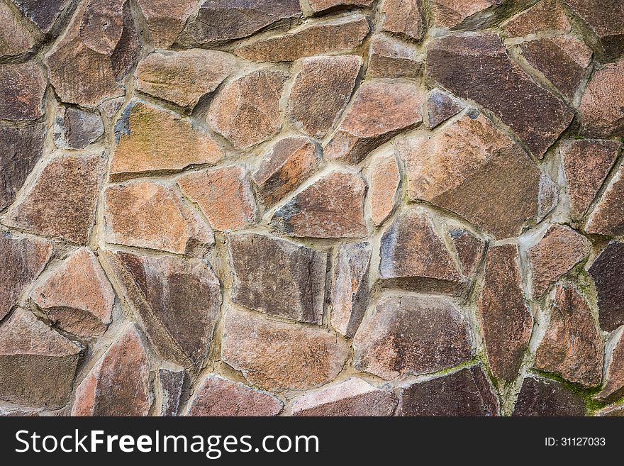 Wall of large crushed colored stone. Wall of large crushed colored stone