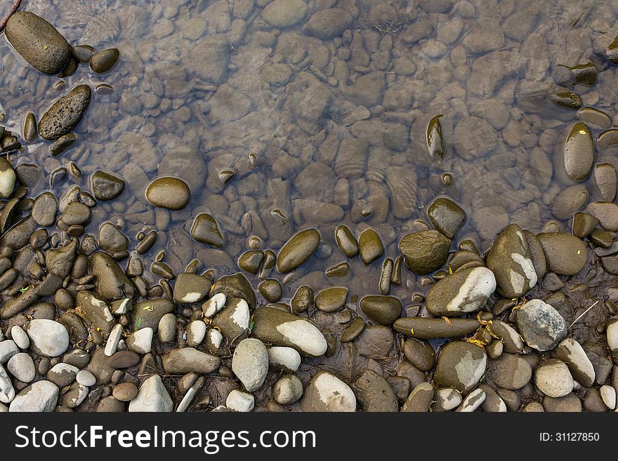 Wide shore with gray river stones and water. Wide shore with gray river stones and water