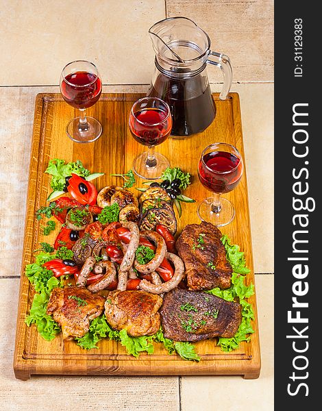 Grilled meat, sausages  and  herbs with wine