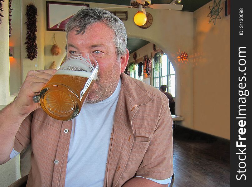 Man drinking beer at a restaurant