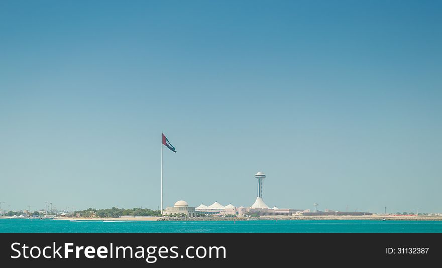 The United Arab Emirates flag, flying next to the Abu Dhabi Heritage Theatre.