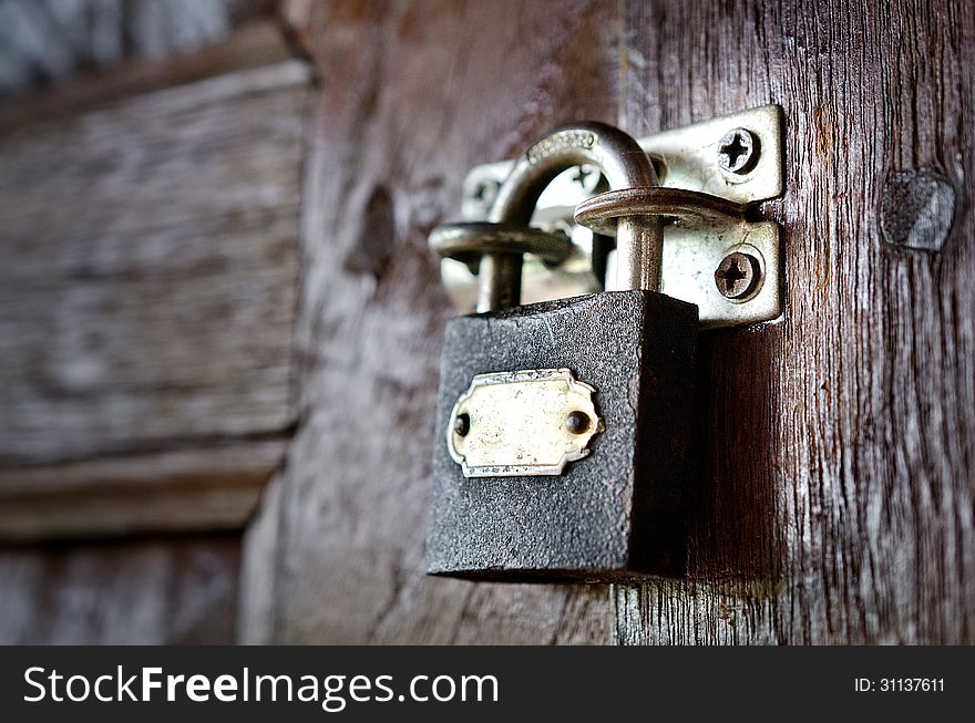 Old rusty vintage lock on a wooden door. Old rusty vintage lock on a wooden door.