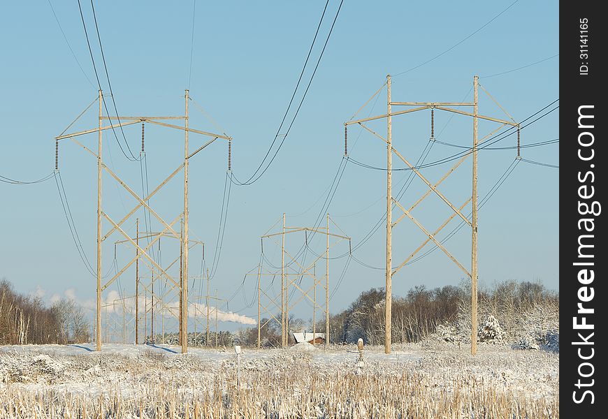 Large Electrical power lines coming from a power plant. Large Electrical power lines coming from a power plant