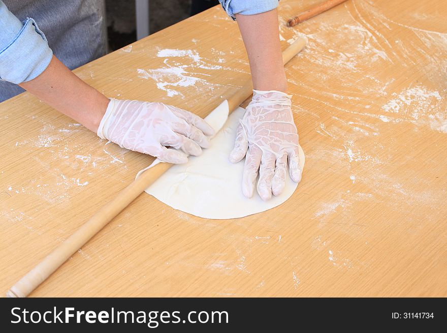 Woman's hands kneading dough with rolling pin for pie. Woman's hands kneading dough with rolling pin for pie