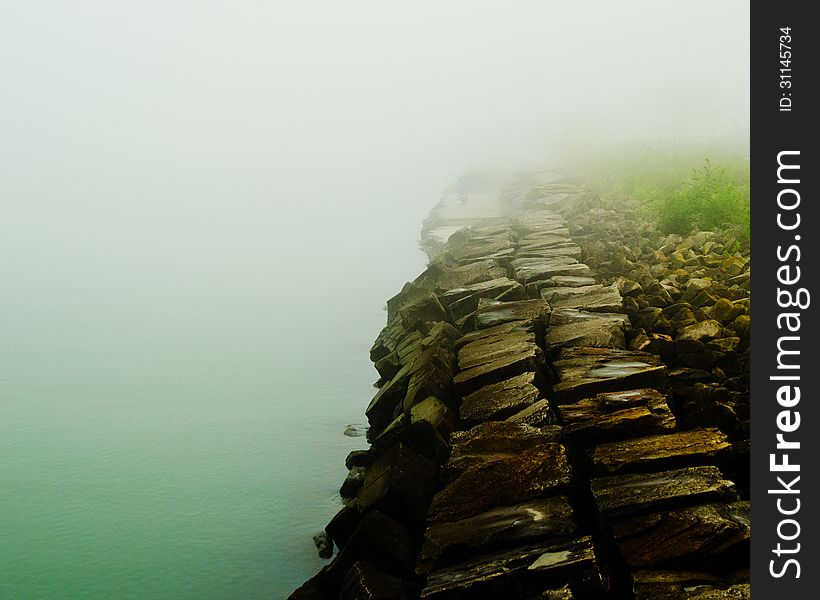 Misty Lake with a stone wall. Misty Lake with a stone wall.