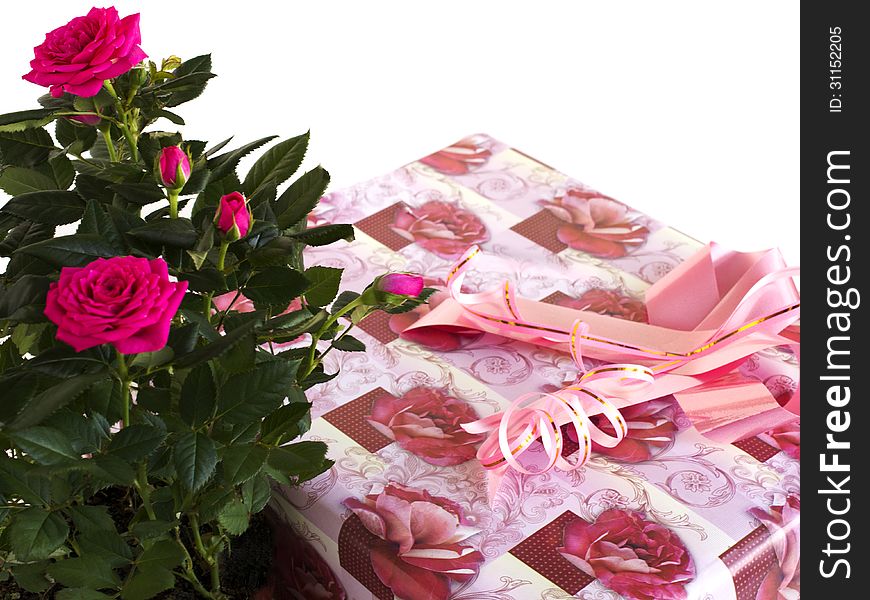 Box with a gift and bouquet of roses on a white background