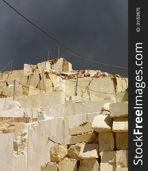 View from the bottom of a quarry of white marble to the sky. View from the bottom of a quarry of white marble to the sky