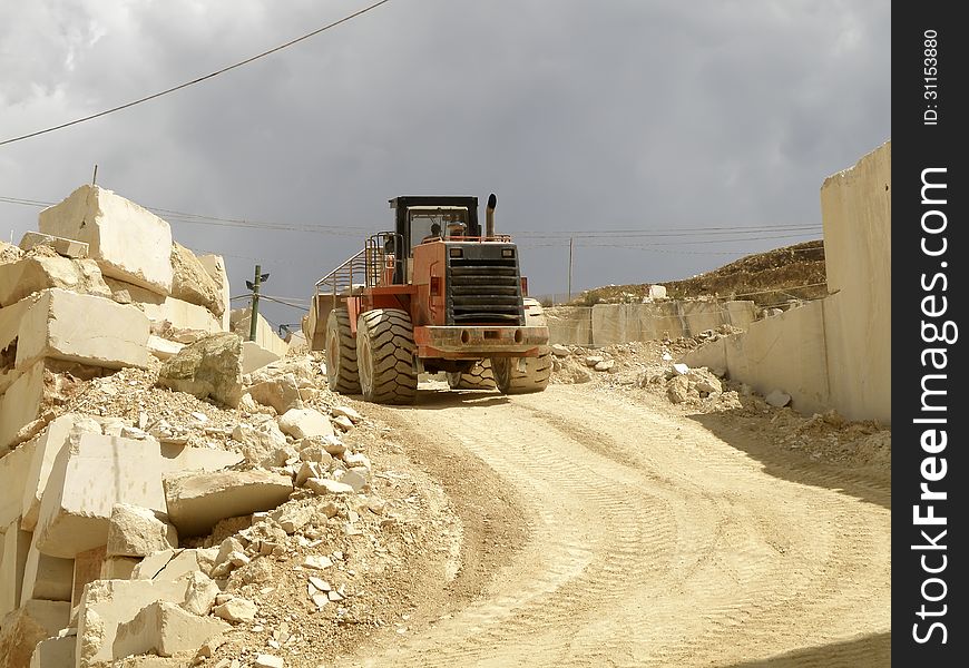 Excavator used for the transportation of the blocks of white marble