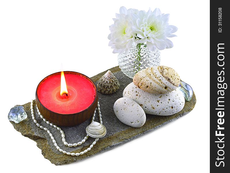 Red candle with shells and white flowers isolated. Red candle with shells and white flowers isolated