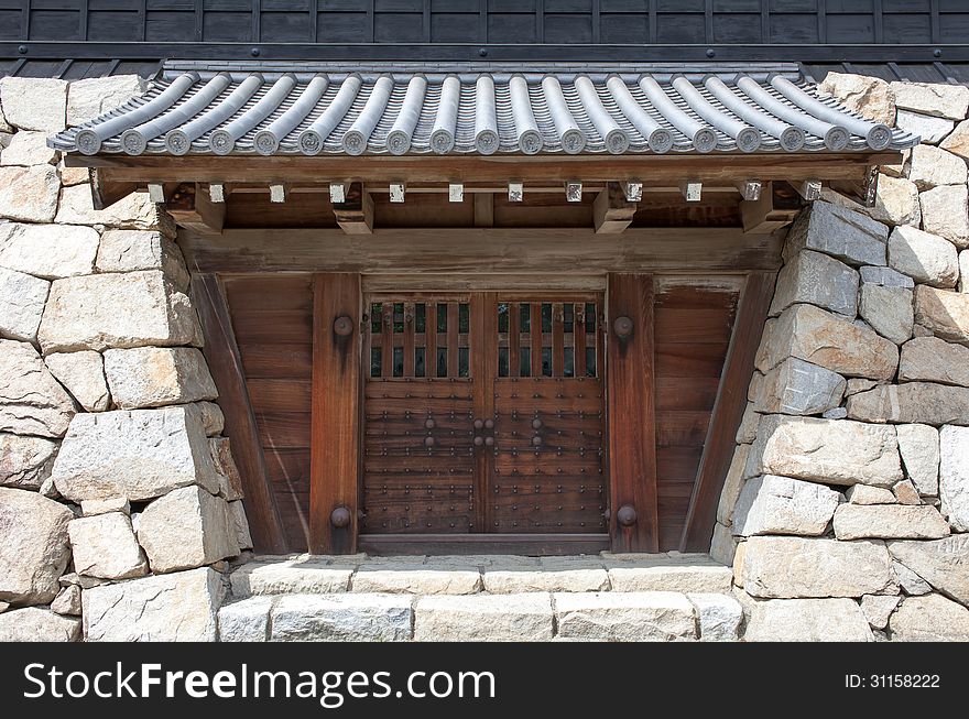 Closed japanese castle gate and rock wall