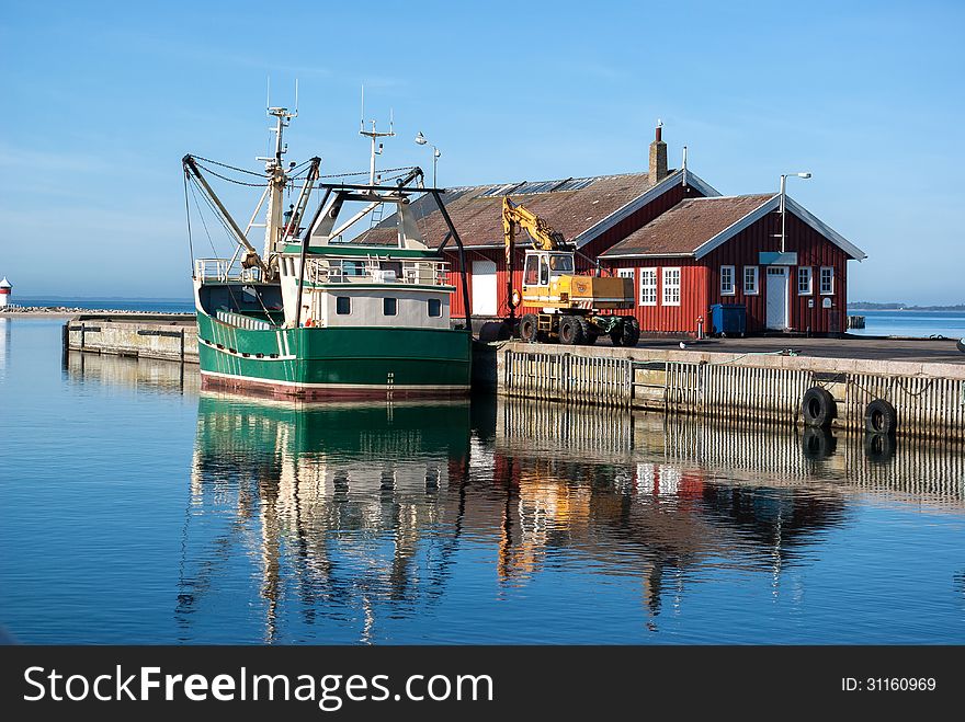 Fishing trawler docking in a Danish commercial harbor