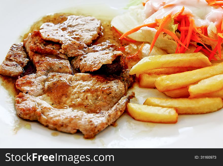 Pork steak with french fires food background. Pork steak with french fires food background