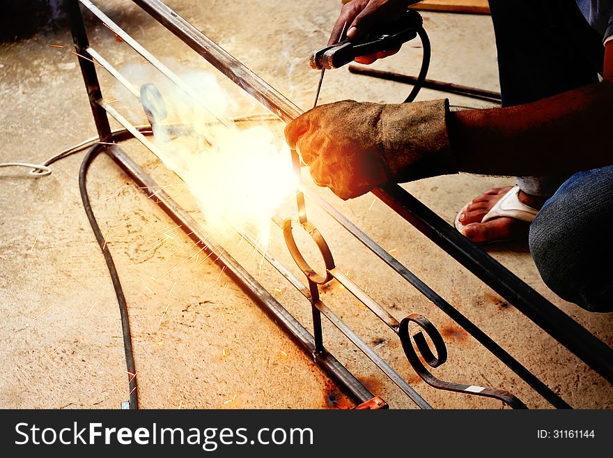 Welding steel with electricity worker construction background