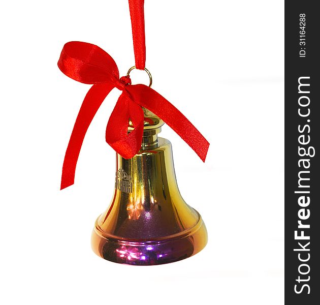 Bell of the yellow metal on a red ribbon with a bow