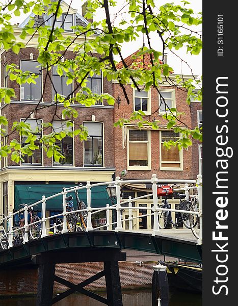 A Typical Scene From The Netherlands Of Bikes On A Brodge Over A Canal. A Typical Scene From The Netherlands Of Bikes On A Brodge Over A Canal