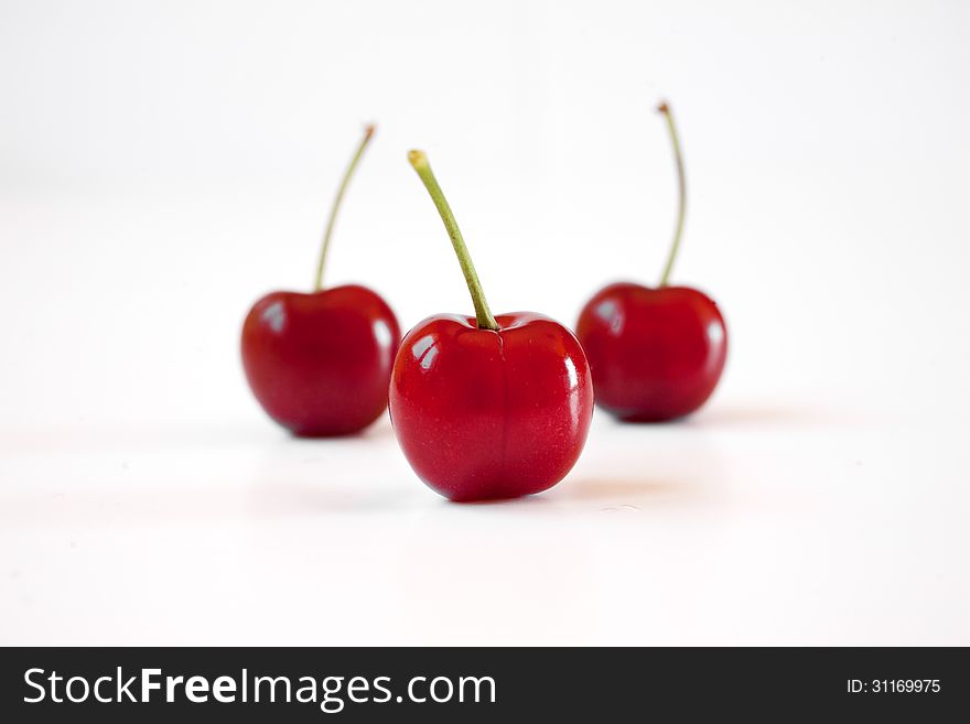 Close up of three cherries on white background. Close up of three cherries on white background