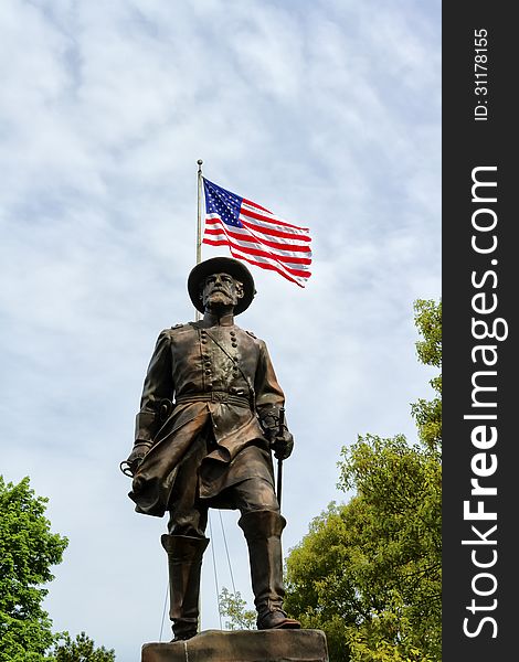 Statue of General William Wells with the American flag in the background