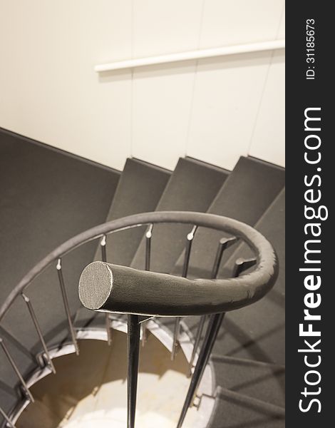 Staircase in modern building interior: handrail first. Staircase in modern building interior: handrail first
