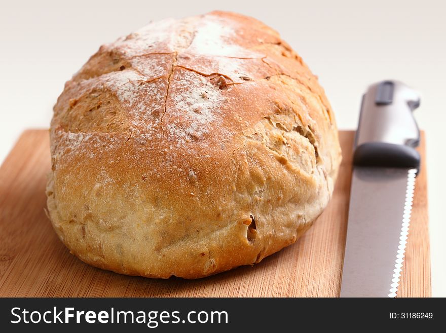 Loaf of bread and knife on a cutting board